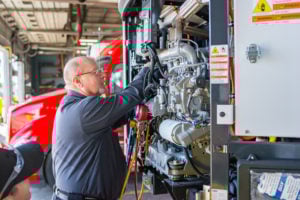 Crosspoint Power and Refrigeration Technician working on a Carrier Trailer Refrigeration Unit