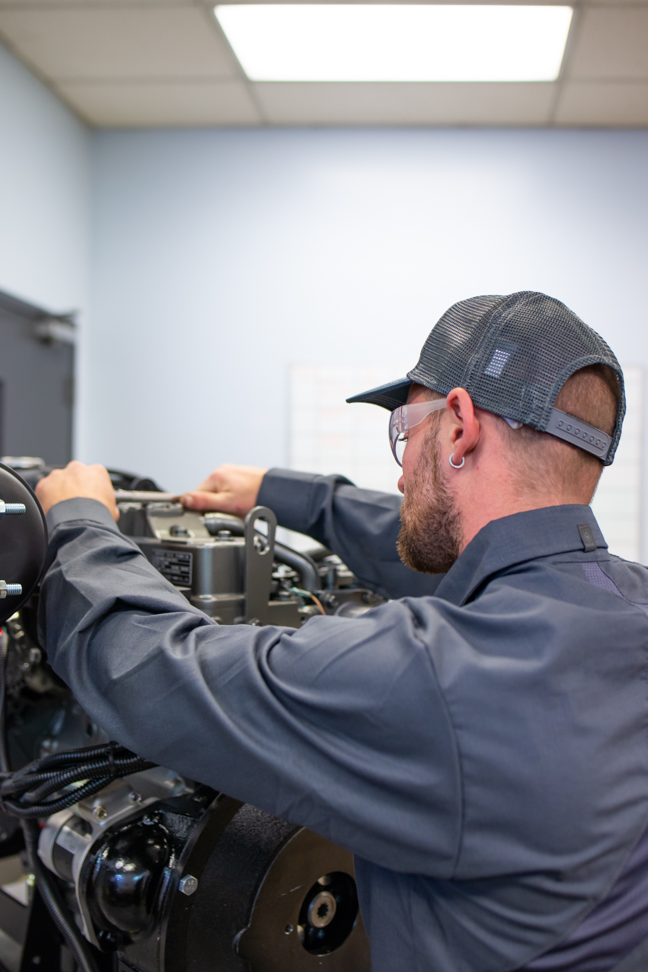 Technician working on a Yanmar Engine