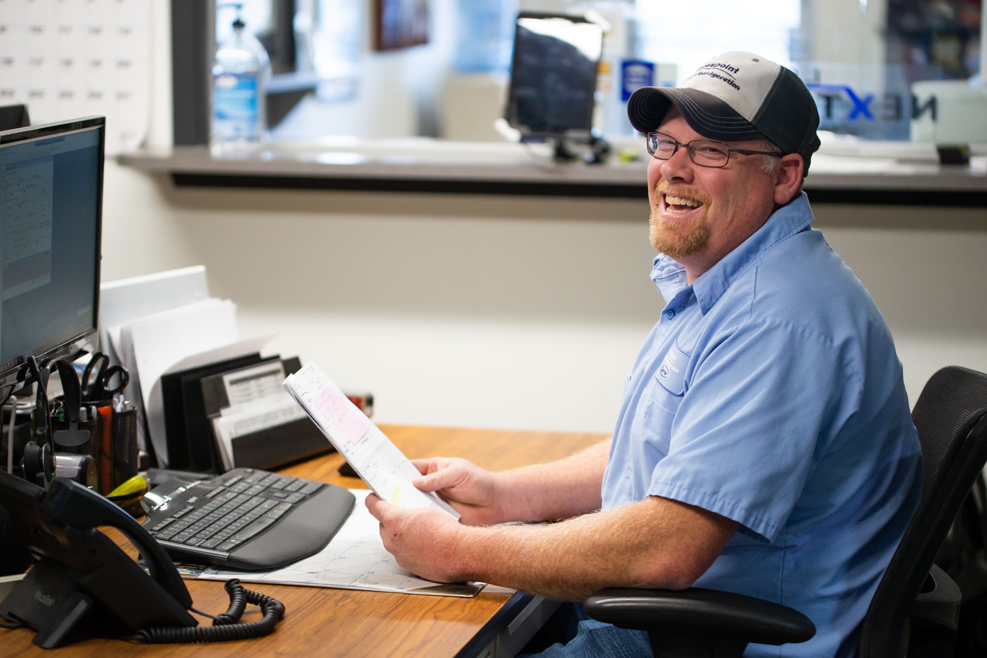 A smiling CSR at his desk working