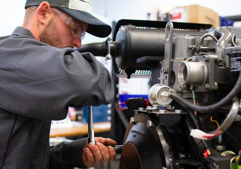 Technician working on a Yanmar Engine